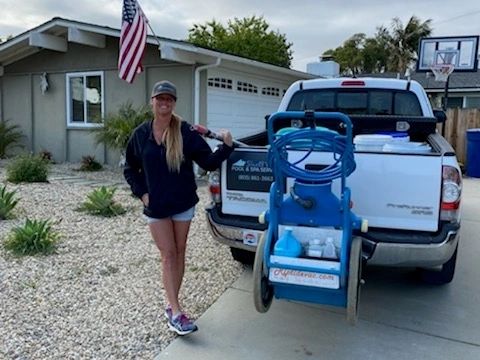 Shell beside her Shell's Pool and Spa Service truck with her equipment cart
